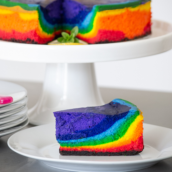 Plate with a slice of cheesecake in rainbow colors