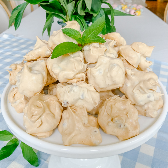 Pecan Meringue Cookies stacked on a pedestal plate