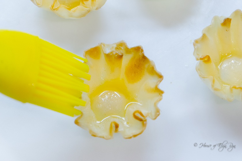 Adding melted butter to a phyllo shell
