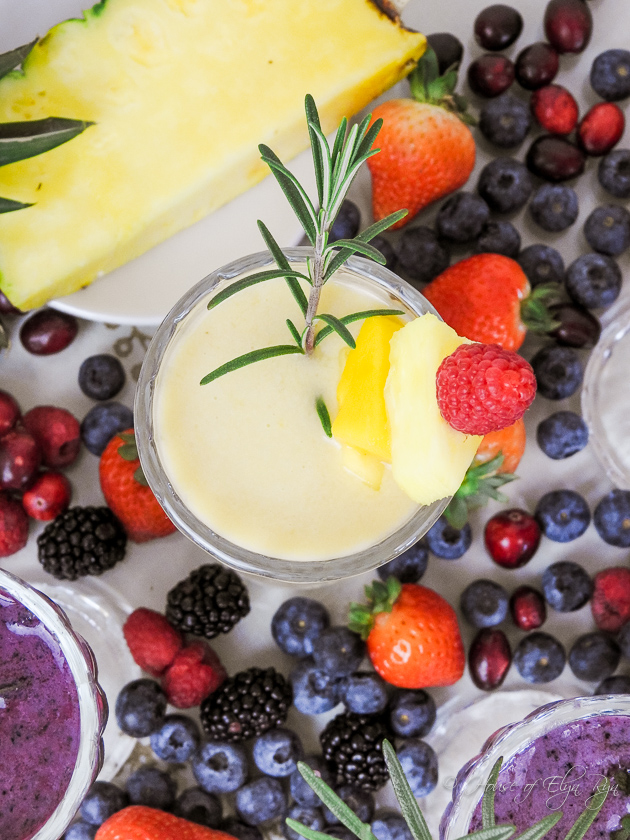 Fresh fruits and a glass with frozen fruits made into a smoothie