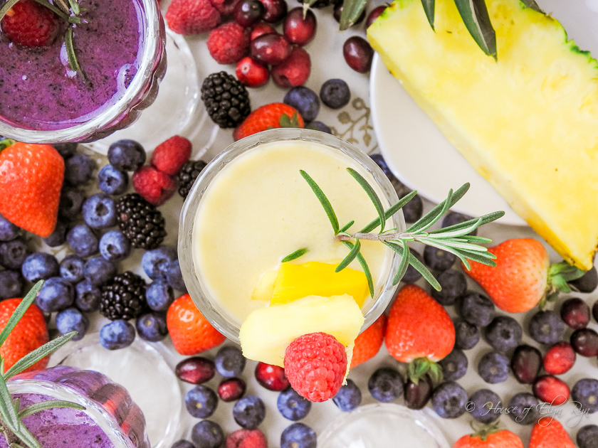 Overhead photo of fruits and pineapple mango smoothie