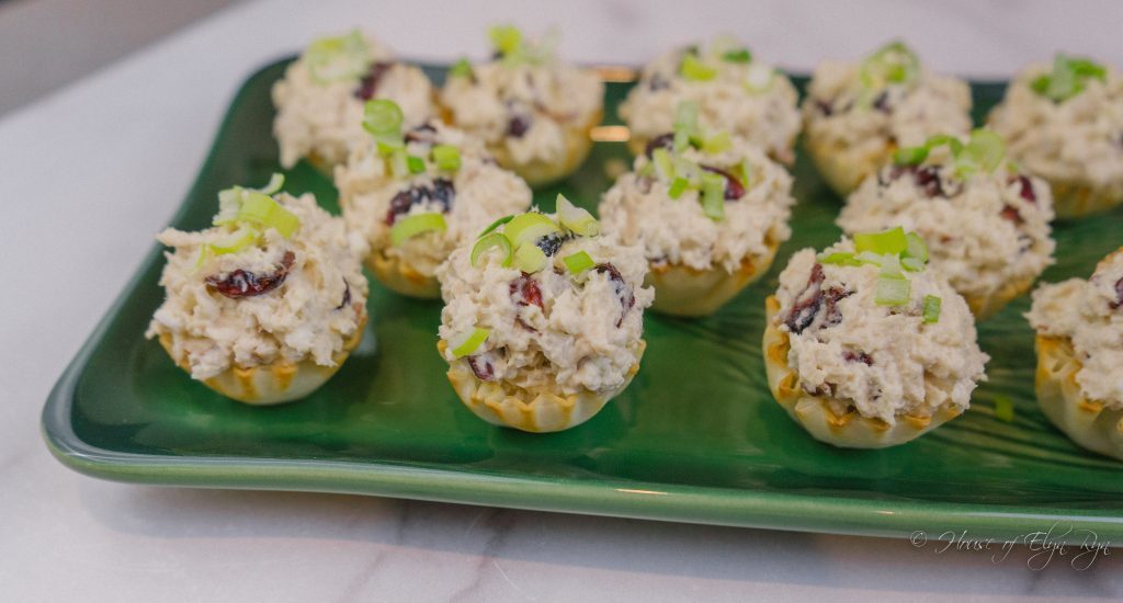 Easy turkey salad appetizers in phyllo shells on a green tray