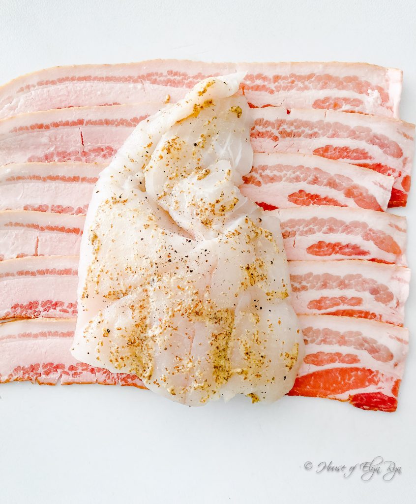 White fish on bacon slices