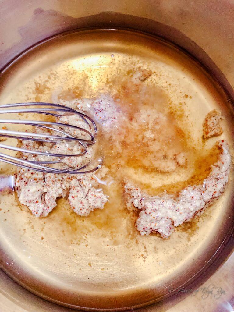 Mixing wine and mustard to cook